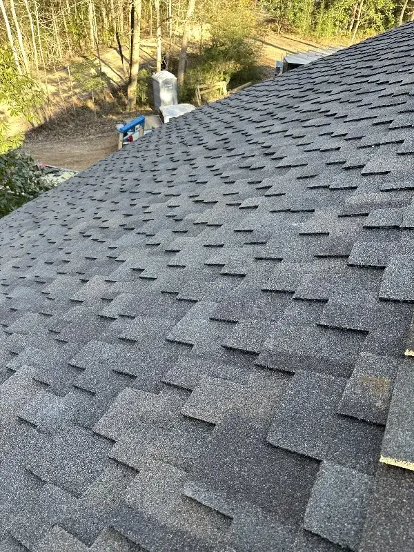 Visual representation of roofing materials including asphalt shingles, metal roofing, and slate tiles